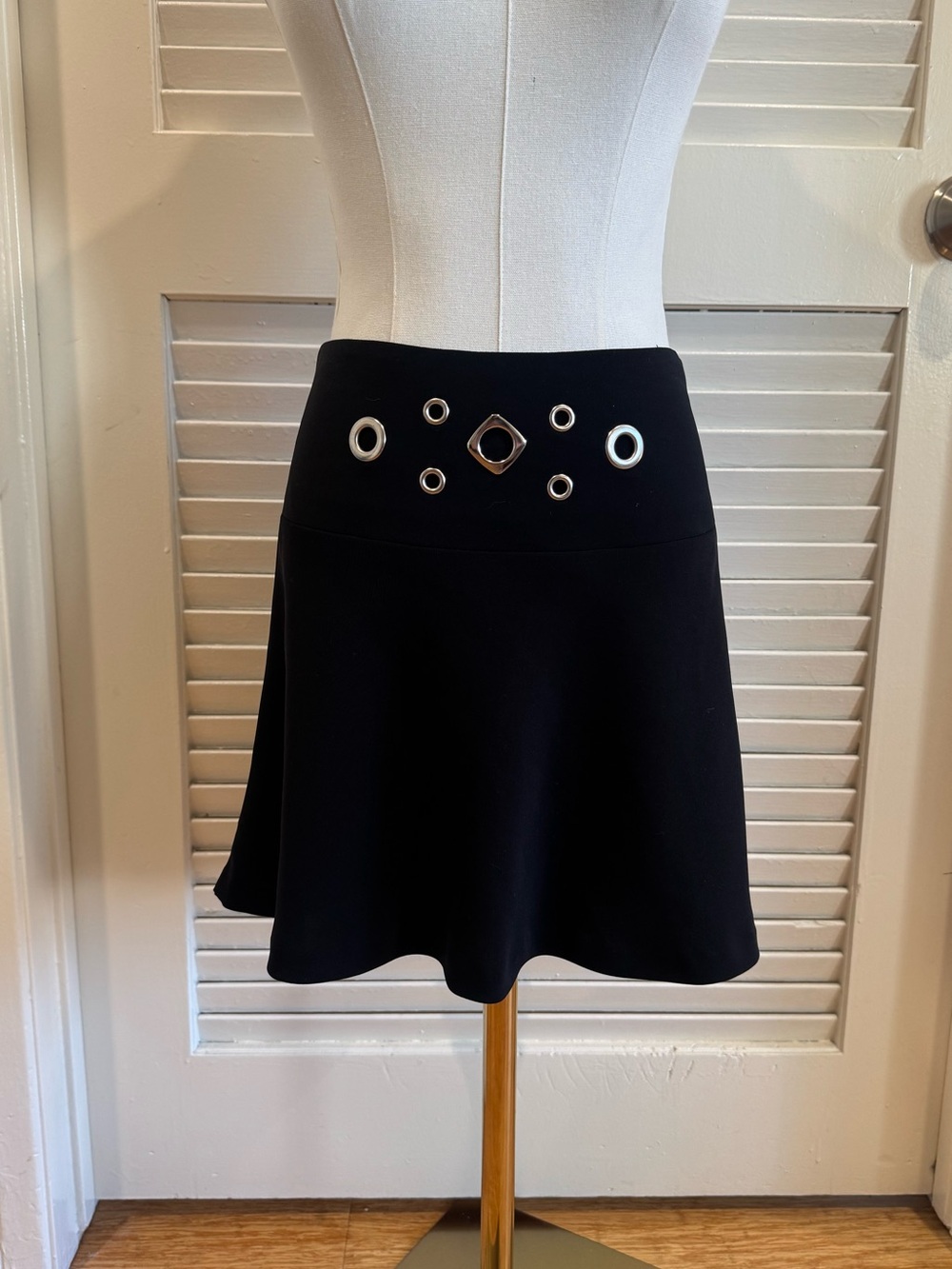Bebe black circle mini circle with silver grommet accents